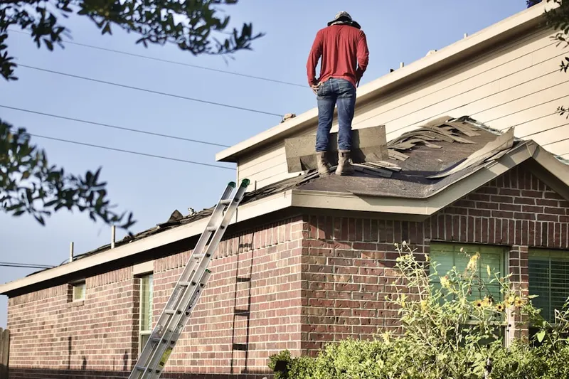 Professional roofer working on a residential roof in Evansville